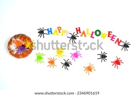 Halloween Spiders. "Happy Halloween" text, rotten pumpkin, colorful letters and spiders in a fun composition. White background. Halloween concept .