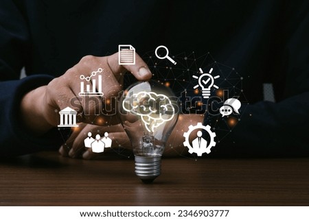 Skills,Knowledge and Ability.Man hand touching light bulb with icon of skills.Thinking, Creativity, Management, Digital skill.Education concept. Royalty-Free Stock Photo #2346903777