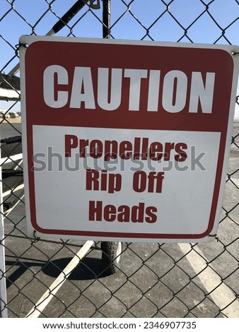 Funny sign found at the airport on a fence