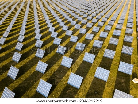 Aerial view of solar power station installed in green field Royalty-Free Stock Photo #2346912219