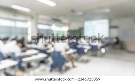 School classroom blur background with blurry student audience back view in class room educational studying, learning in lecture hall with teacher screen slide presentation, back to school concept  Royalty-Free Stock Photo #2346923059