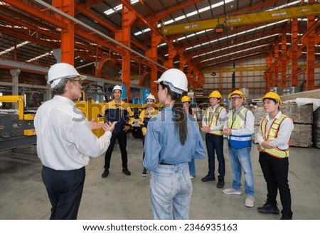 Warehouse safety meeting, people with hard hats. Industrial teamwork. Royalty-Free Stock Photo #2346935163