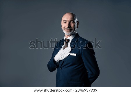Portrait of guiding elderly caucasian male staff. Royalty-Free Stock Photo #2346937939