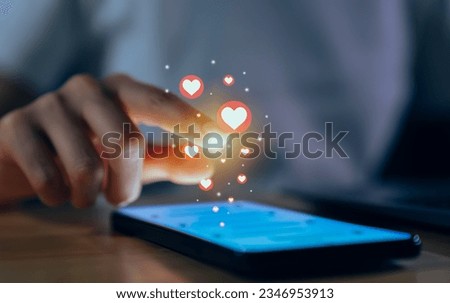 Hand using smartphone and chatting on social media with show heart icon.