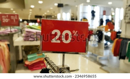 Clothing store with 20 percent red discount banners. Discount, promotions, sales in shopping centers and shops.