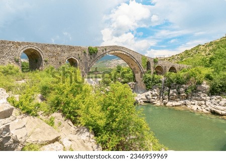 Mesi Bridge in Albania is stunning example of architectural brilliance across the Kir River in the charming village of Mesi. This stone bridge has a rich history, dating back to time of Ottoman Empire Royalty-Free Stock Photo #2346959969