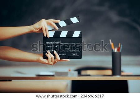 
Hands Holding a Film Slate in a School Classroom 
Professor saying action for going back to school 
