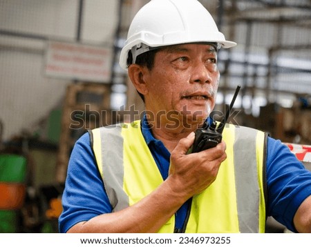 man male person people white hardhat helmet older young adult safety talkie walkie speak talk discussion communication engineer radio technology manager planning professional antennae work job site  Royalty-Free Stock Photo #2346973255
