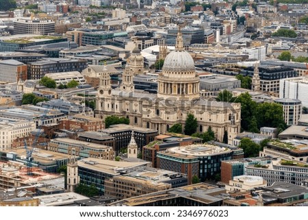 London cityscape with St Paul's Cathedral and urban city buildings. The London aerial panoramic skyline view shows St. Paul's cathedral dome, UK mixed use, office and residential buildings. No people.