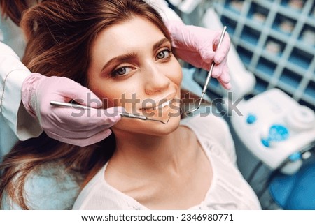 Professional woman dentist is working. Woman patient during a dental procedure. Dental care. Overview of caries prevention. Royalty-Free Stock Photo #2346980771