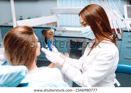 Professional woman dentist is working. Woman patient during a dental procedure. Dental care. Overview of caries prevention. Royalty-Free Stock Photo #2346980777