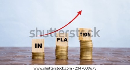 inflation word on wooden cube coins in idea for RBI consider interest rate hike, world economics, and inflation control concept Royalty-Free Stock Photo #2347009673