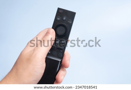 Smart television remote controller isolated on blue background. 