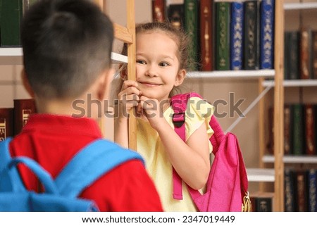 Cute little girl in library Royalty-Free Stock Photo #2347019449