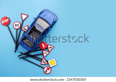 driver education and safety measures through driving schools and academies, car and road signs on a blue background, copy space