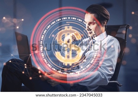 Attractive young businessman sitting and using laptop with abstract red digital dollar coin with polygonal bokeh mesh on blurry office background. Online banking and trade concept. Double exposure.
