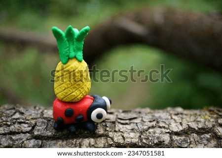 Ladybug made of plasticine with pineapple. Fruits and vitamins.