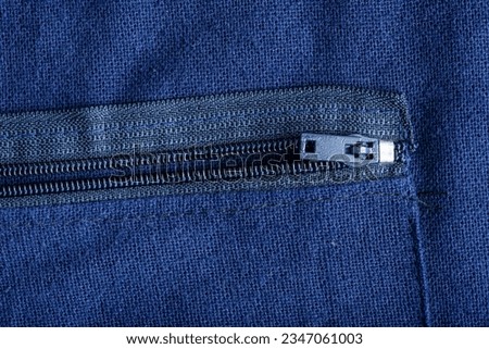 Close up detail of zip on blue cloth 