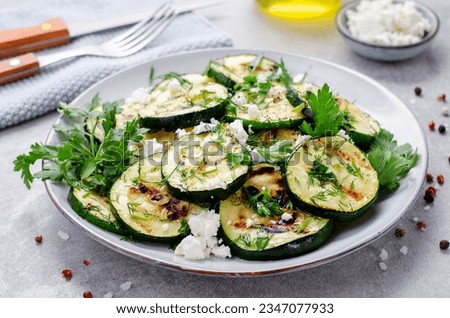 Grilled Zucchini, Feta and Herbs Warm Appetizer, Salad on Bright Grey Background