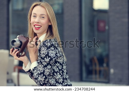 outdoor photo blonde girl with a camera