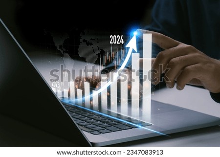 Business development to success.Businessman hand pointing arrow up and graph.Profit and growing growth plan.Businessman analyzes profitability.positive indicators in 2024.