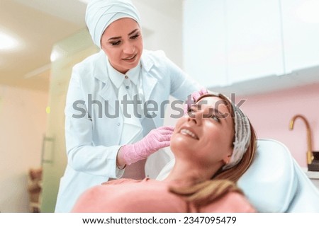 The doctor performs aesthetic procedures with a needle Royalty-Free Stock Photo #2347095479