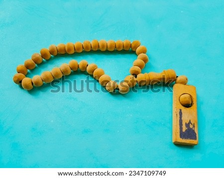 holy "tasbih" for moslem isolated on green background  