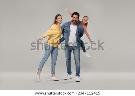 Portrait of happy family on light grey background