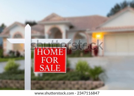 Home For Sale Real Estate Sign and Beautiful New House