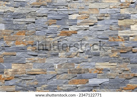 
Wall made of colored stones, pattern, decoration, hotel wall