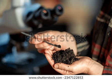 young Female soil scientist holding a soil in a hand in a soil laboratory in australia  Royalty-Free Stock Photo #2347122853