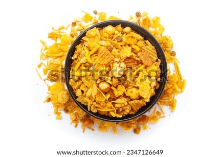 Close-up of Makhana Mix Indian namkeen (snacks) on a ceramic black bowl. Isolated on white background. Top view