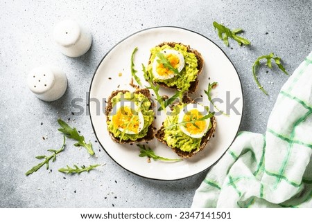 Whole grain bread with avocado and boiled eggs. Royalty-Free Stock Photo #2347141501