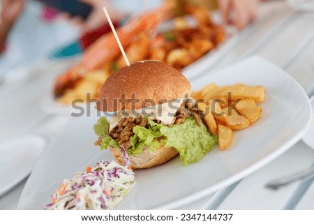 Tasty burger with french fries