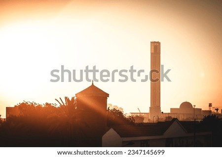 Picture of Algerian mosque during sunrise .