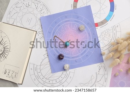Natal charts for making forecast of fate and astrological items for fortune telling on table, flat lay Royalty-Free Stock Photo #2347158657
