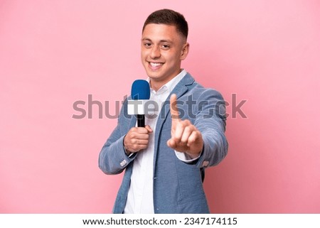 Young brazilian presenter man isolated on pink background showing and lifting a finger Royalty-Free Stock Photo #2347174115