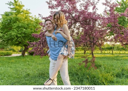 This pic captures a young couple goofin' around in the park. It's all about that joy, good times, fun evening, great relationship, and carefree vibes