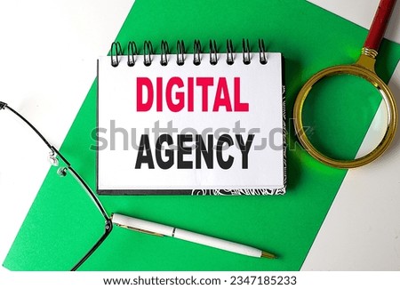 DIGITAL AGENCY text on a notebook on green paper