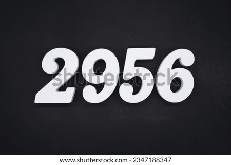 Black for the background. The number 2956 is made of white painted wood.