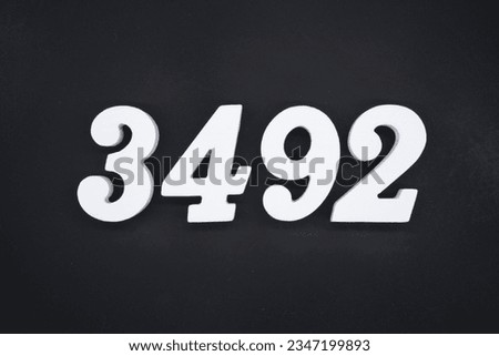 Black for the background. The number 3492 is made of white painted wood.
