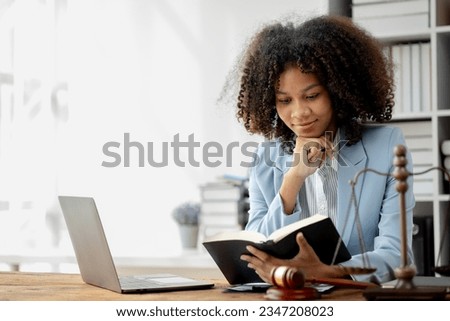 American woman is legal litigation attorney, Female lawyer is in a law firm drafting contracts and reading client case details to study and find a solution to win the case. Lawyer and justice concept. Royalty-Free Stock Photo #2347208023