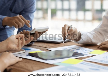 Business meeting together to work on paperwork. Brainstorm ideas to analyze financial statements for business investments. Financial and investment account planning.
