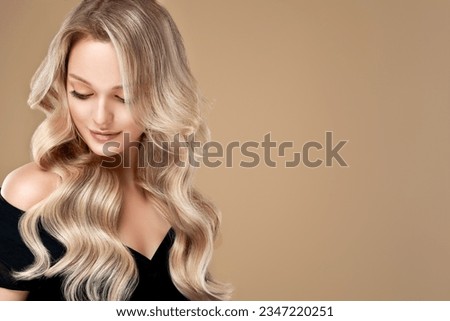 beautiful girl  hair coloring in ultra blond. Stylish hairstyle curls done in a beauty salon. Fashion, cosmetics and makeup.