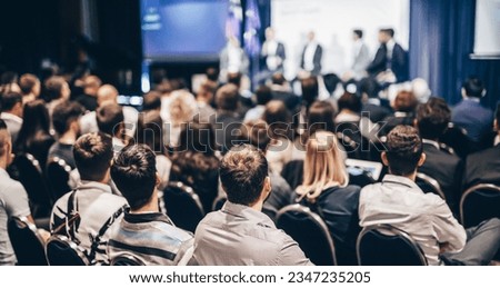 Speaker giving a talk in conference hall at business event. Rear view of unrecognizable people in audience at the conference hall. Business and entrepreneurship concept Royalty-Free Stock Photo #2347235205