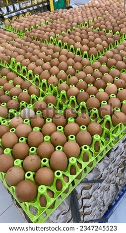 The arrangement of eggs on a rack in a supermarket or grocery store is usually organized in a systematic and visually appealing manner to make it easy for customers to select the eggs they need. 