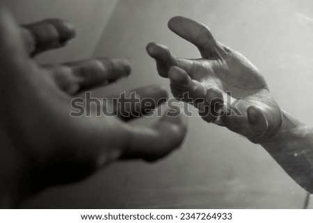 A reflection or image of a hand in a mirror.