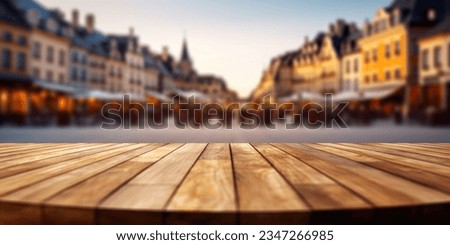The empty wooden table top with blur background of town square. Exuberant image.