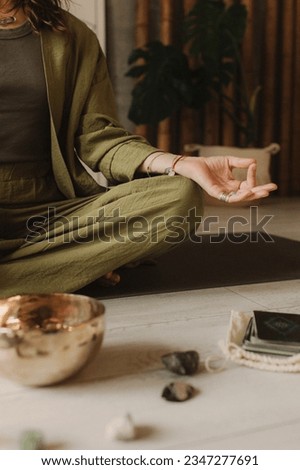 Woman playing on Tibetan singing bowl while sitting on yoga mat. Vintage tonned. Soft focus blurred and noise effect. Royalty-Free Stock Photo #2347277691