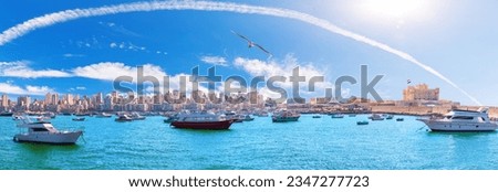 Sea panorama of Alexandria with boats, old city buildings and the citadel of Qaitbay, Egypt